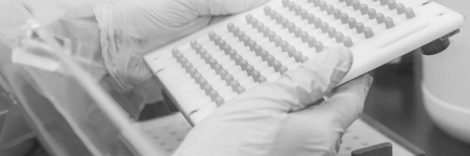 Technician holding a tray of capsules